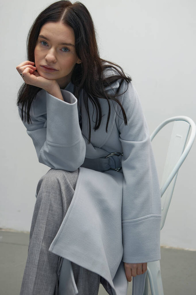 Beautiful fashion girl posing in a stylish coat - Фото, зображення