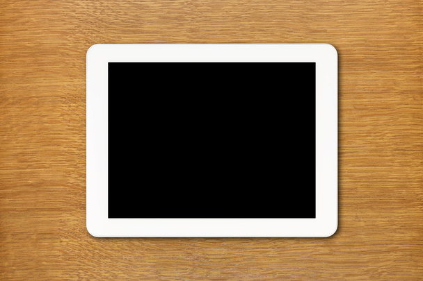 Tableta blanca PC con pantalla negra sobre la mesa
 - Foto, imagen