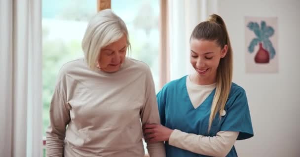 Physiotherapist, patient and assistance with walking in hospital for recovery, injury or rehabilitation. Elderly woman, help and talk with caregiver from surgery, mobility and support in facility. - Footage, Video
