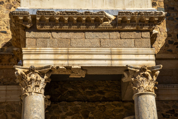 Ornate cornice with perched dove of the Roman Theater of Merida with Greek and Roman marble columns, and a needle trap on the cornice so that pigeons do not spoil the monument. - Photo, Image