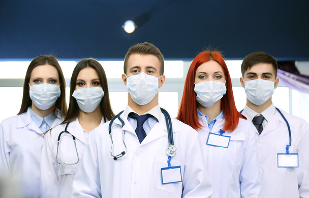 Medical workers in medical masks in conference room - 写真・画像