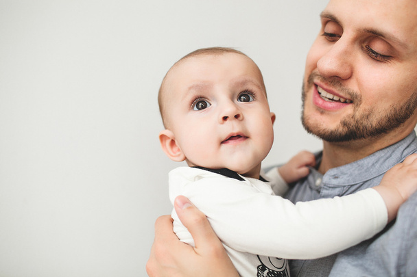 Happy father holding baby son in hands with isolated background - Photo, Image