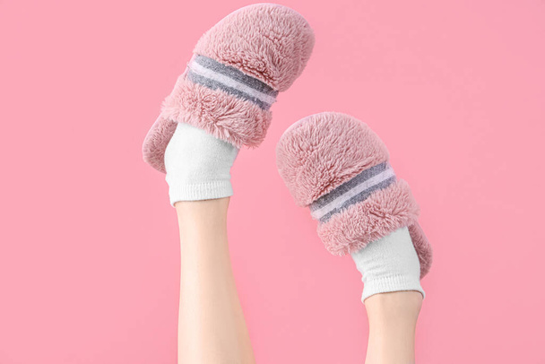 Ženské nohy v měkkých pantoflích na růžovém pozadí - Fotografie, Obrázek