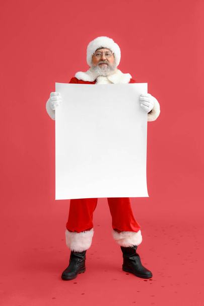 Santa Claus with blank poster on red background - Photo, Image