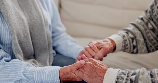 Ancianos, pareja y tomados de la mano para la empatía, el amor y la amabilidad para la relación o la jubilación en el sofá del hogar. Senior, personas y confort, conexión y comprensión en el sofá en la sala de estar. - Metraje, vídeo
