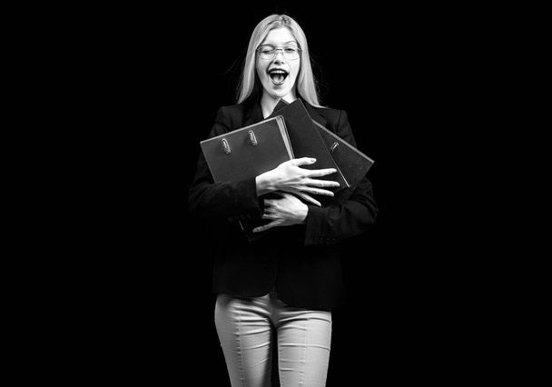 Businesswoman or secretary winking and holding folders , black isolated - Foto, afbeelding