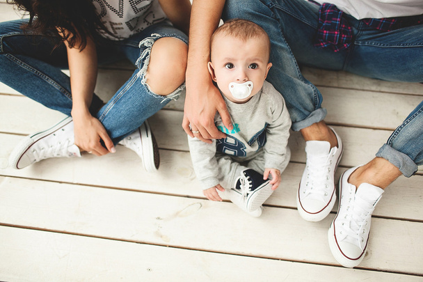 Young hipster father, mother and baby boy on wooden floor - Fotografie, Obrázek