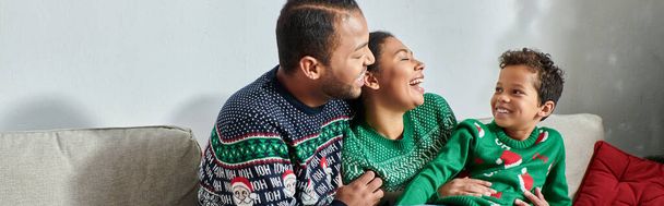 happy african american family in warm sweaters smiling happily at each other, Christmas, banner - Foto, imagen