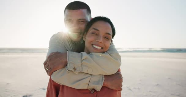 Face, smile and couple hug at beach on vacation, holiday or summer travel with wind mockup. Portrait, happy man embrace woman at ocean or sea on lens flare outdoor together in support, love or care. - Footage, Video