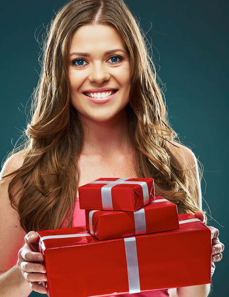 Woman holding red gift boxes - Foto, imagen