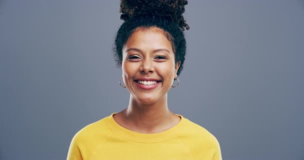 Woman, wink and smile in studio, face and emoji or secret, confident and flirting in mockup. Happy female person, portrait and flirty personality or signal, blink and mindset on gray background. - Séquence, vidéo