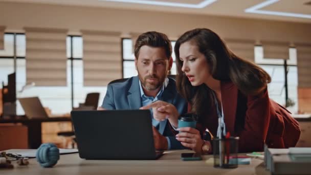 Business couple discussing computer screen at office closeup. Executive talking office assistant at laptop table. Thoughtful woman pointing screen laughing with man colleague at meeting room together - Footage, Video