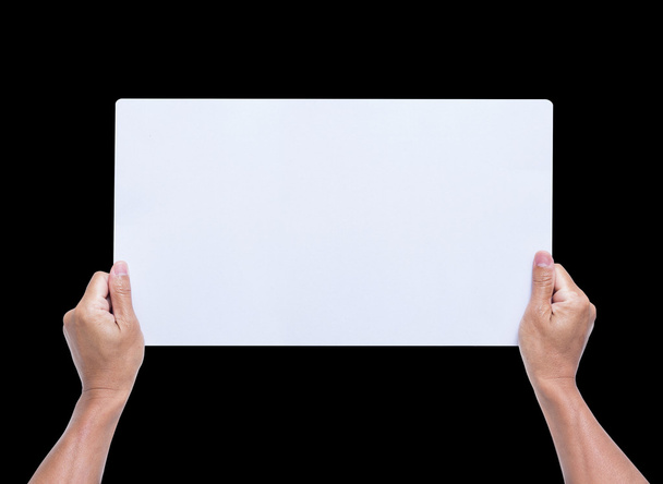 Hands holding blank paper isolated on black background - Foto, Imagen