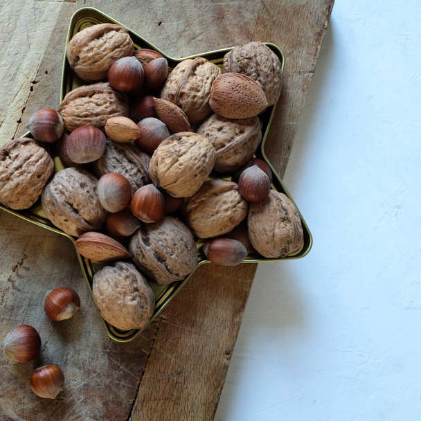 Group of mixed nuts isolated on wooden table. Snack food. Healthy food concept. Overhead view. - Photo, Image