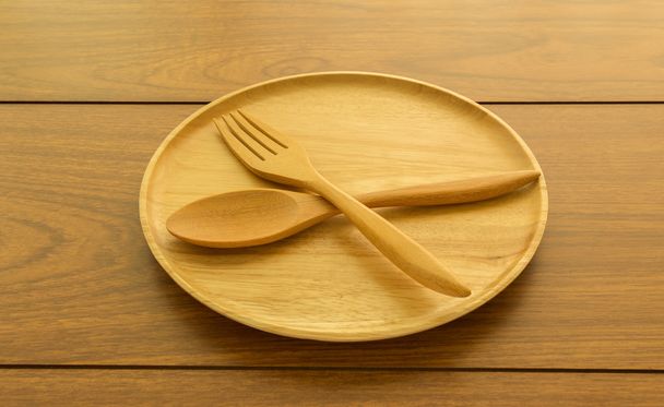Wooden plate spoon fork with retro color effect - 写真・画像