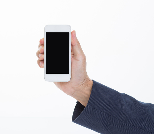 Businessman hand holding mobile phone on white background - Foto, afbeelding