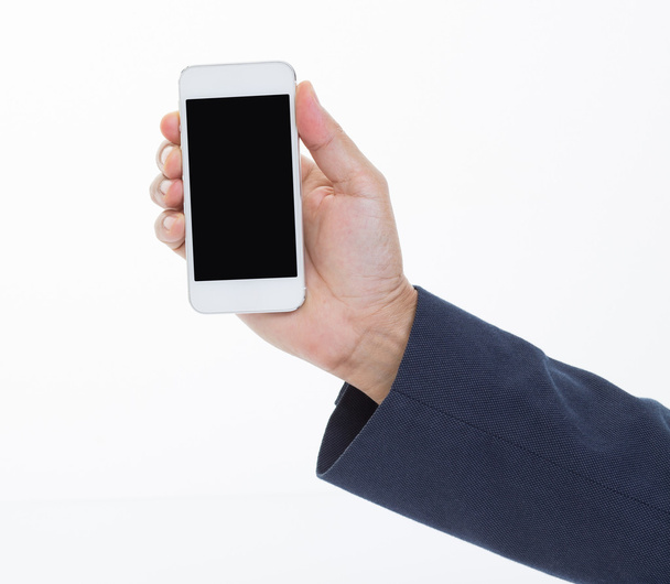 Businessman hand holding mobile phone on white background - Foto, afbeelding