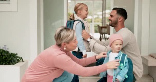 Mother, father and children hug with backpack for kindergarten, hug at home getting ready and happy family love in morning. Mom, dad and kids with school bag for daycare, learning and development - Footage, Video