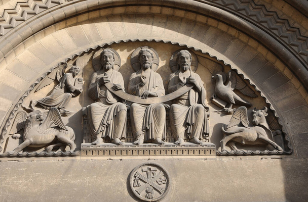 four winged creatures that symbolise the Four Evangelists surround Christ in Majesty on the Romanesque tympanum of Church - Photo, Image