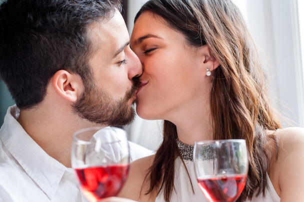 Romantic couple kissing at dinner. - Fotó, kép