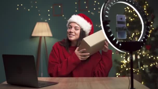 Influencer filmt Weihnachts-Unboxing-Video für soziale Medien. Kopierraum - Filmmaterial, Video