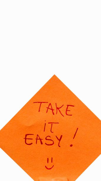 Take it easy handwriting text close up isolated on orange paper with copy space. - Photo, Image
