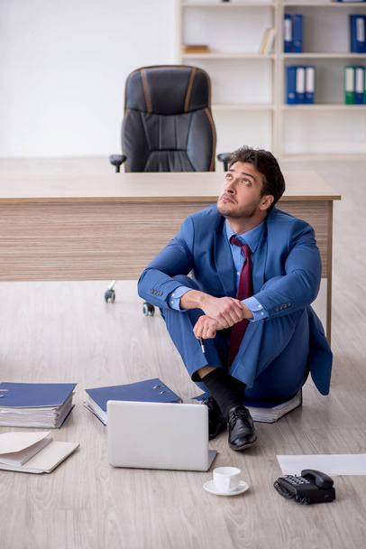 Young employee unhappy with excessive work at workplace - Photo, Image