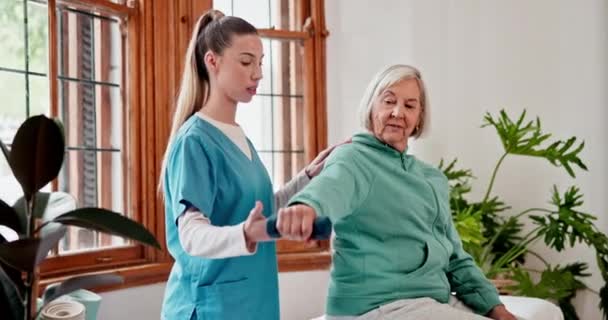 Physiotherapy, nurse and senior woman with dumbbell, stretching and healthcare with rehabilitation, wellness and talking. Person, patient and elderly lady with caregiver and physical therapist. - Footage, Video