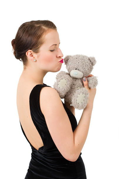 attractive kissing brunette holding teddy bear - Fotografie, Obrázek