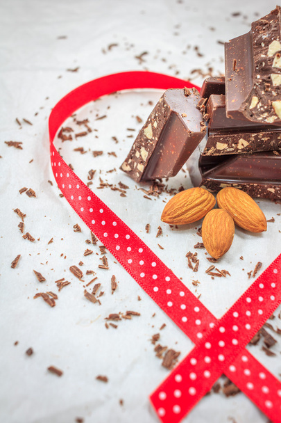 Dark chocolate and almonds decorated with red ribbon - Foto, immagini
