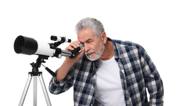 Senior astronomer looking at stars through telescope on white background - 写真・画像