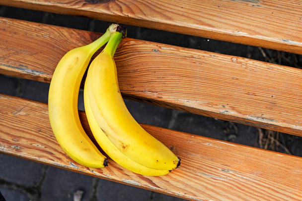 bos rijpe gele banaan op een houten ondergrond. - Foto, afbeelding