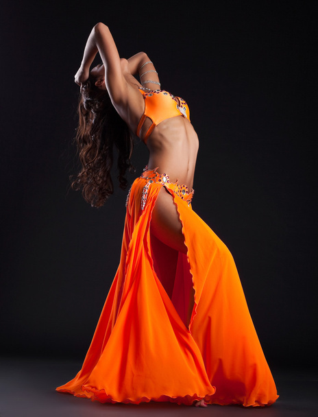 Expressive woman posing in orange arabic costume - Fotoğraf, Görsel
