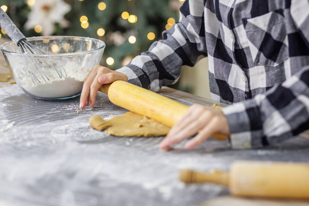 Christmas and New Year bakery. Close up of children hands cooking traditional gingerbread cookies - Photo, Image