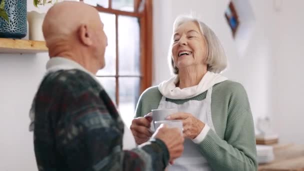 Senior couple, laughter or coffee in conversation in kitchen, love or joke in retirement. Elderly man, woman or marriage to espresso drink in morning, relax together or calm, comedy talking in house. - Footage, Video