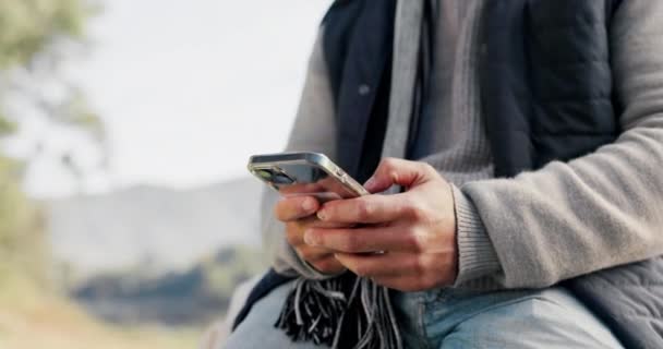 Closeup, outdoor and hands with a smartphone, man and typing with social media, internet connection and contact. Male person, guy and cellphone with a mobile app, outside and online reading for info. - Footage, Video