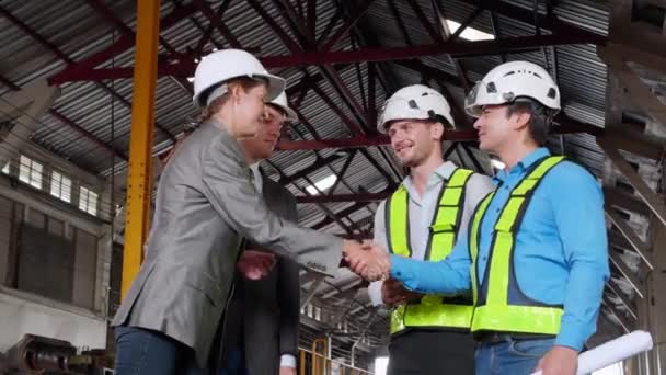 Team young caucasian engineer and partner checking and examining train while doing agreement and handshake in station, team technician and partnership shaking hands, transportation concept. - Footage, Video