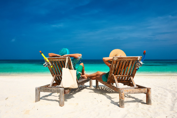Couple in green relax on a beach at Maldives - Photo, Image