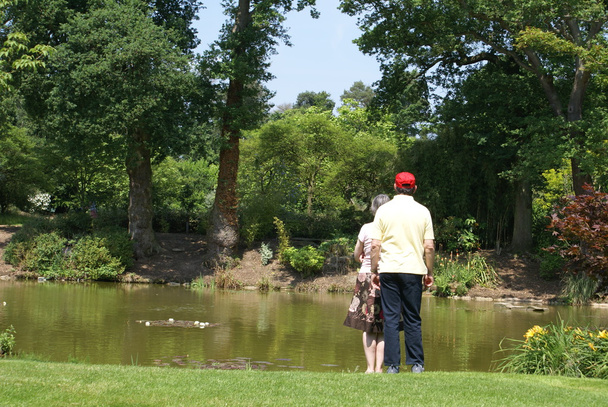 Couple standing at a lakeside - Photo, Image