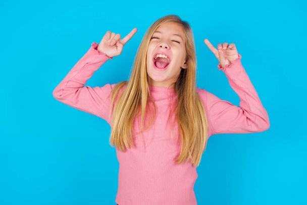 Photo of crazy pretty teen girl screaming and pointing with fingers at hair closed eyes - Photo, Image