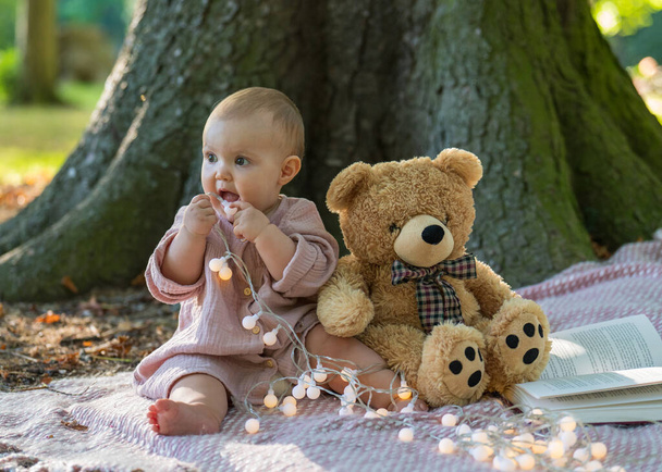 baby girl, bear, teddy, looking, playing, laughing baby, blond, children playing, cute baby, forest trees, blonde hair, daylight, trees, children, close up, baby background, nature parkland, joy, nature, outdoor, small, park, lifestyle, daughter, hol - Photo, Image