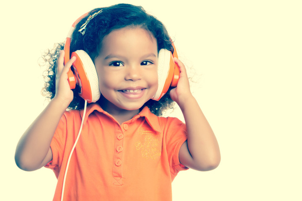 Small girl listening to music - Foto, Imagen