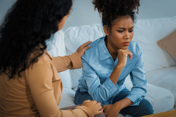 Sad PTSD woman patient in crucial therapy for mental health with psychologist, depression or grief after life failure. Frustrated trauma young woman talking to a psychologist about emotion in clinic - Photo, Image