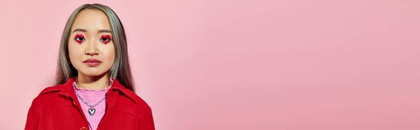 portrait of young asian woman with heart shaped eye makeup and dyed hair posing on pink, banner - Photo, Image