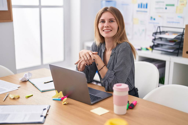 Młoda blondynka biznes pracownik za pomocą laptopa pracy w biurze - Zdjęcie, obraz