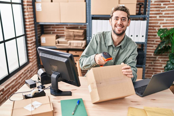 Young man ecommerce business worker scanning package at office - Foto, Imagem