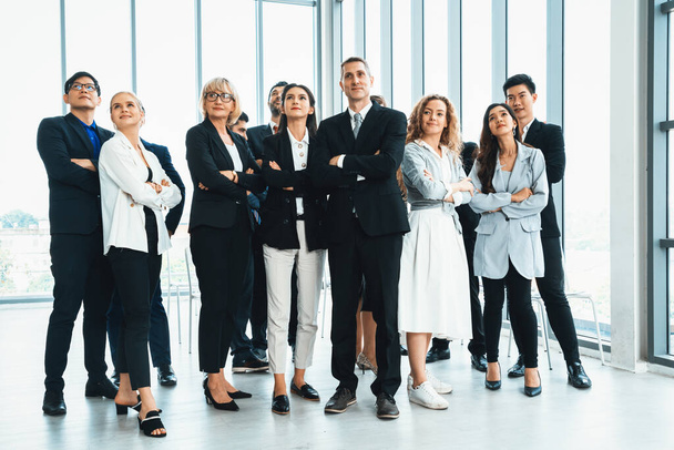 Successful business people standing together showing strong relationship of worker community. A team of businessman and businesswoman expressing a strong group teamwork at the modern office. Jivy - Photo, Image