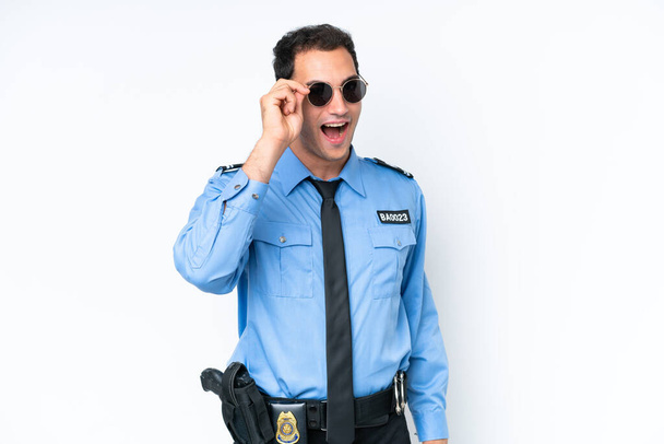 Young police caucasian man isolated on white background with glasses and surprised - Photo, Image