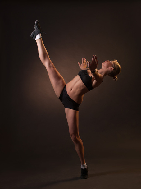 beautiful woman doing a split standing - Фото, изображение