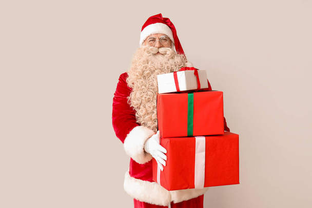 Santa Claus with Christmas gifts on white background - Photo, Image